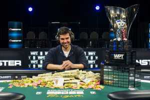 Anthony Merulla with his top prize money, the WPT Champions Club Trophy and limited edition Headphones